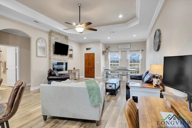 204 Nolan Farms, Winona, TX 75792 - living room featuring light hardwood / wood-style floors, crown molding, a raised ceiling, and a multi sided fireplace