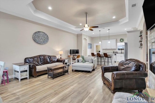 204 Nolan Farms, Winona, TX 75792 - living room featuring a tray ceiling, light hardwood / wood-style flooring, ornamental molding, and ceiling fan