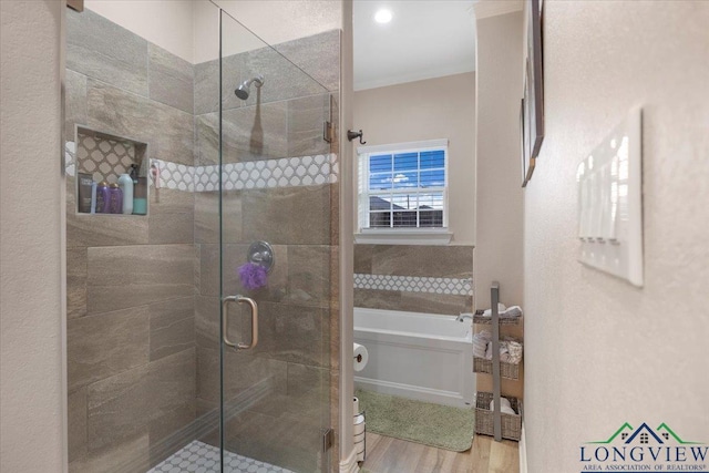 204 Nolan Farms, Winona, TX 75792 - bathroom featuring hardwood / wood-style floors and shower with separate bathtub