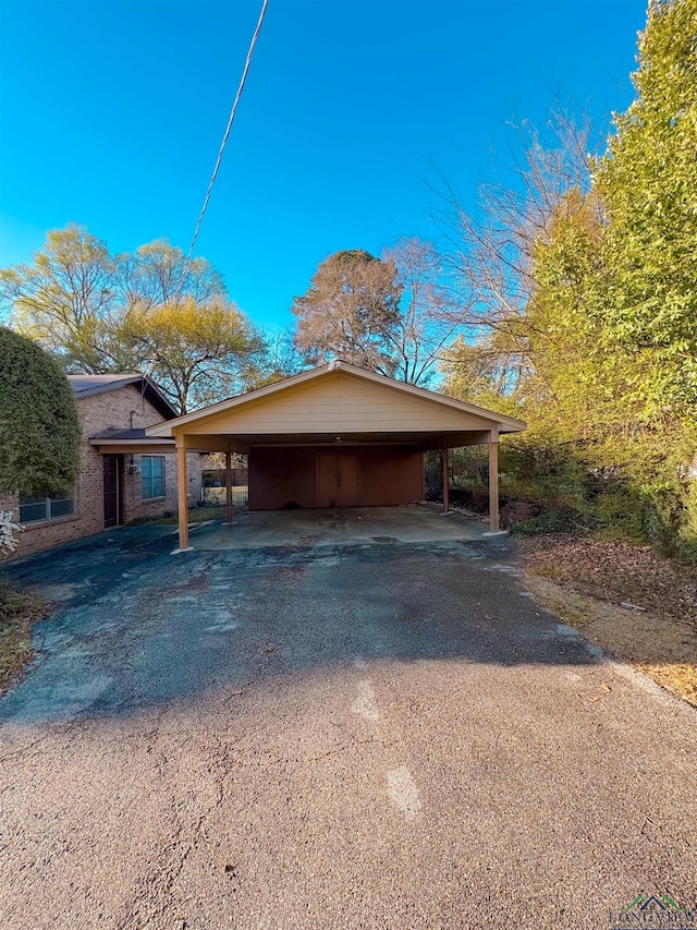 300 Delwood Dr, Longview, TX 75605 - view of home's exterior with a detached carport and aphalt driveway