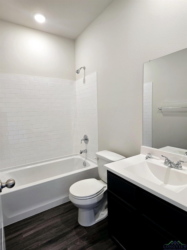 full bathroom featuring wood finished floors, toilet, vanity, and shower / bath combination