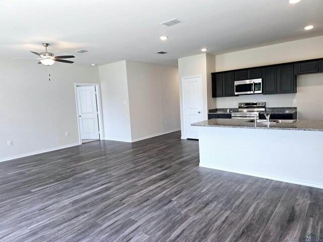 kitchen featuring visible vents, stainless steel appliances, and open floor plan