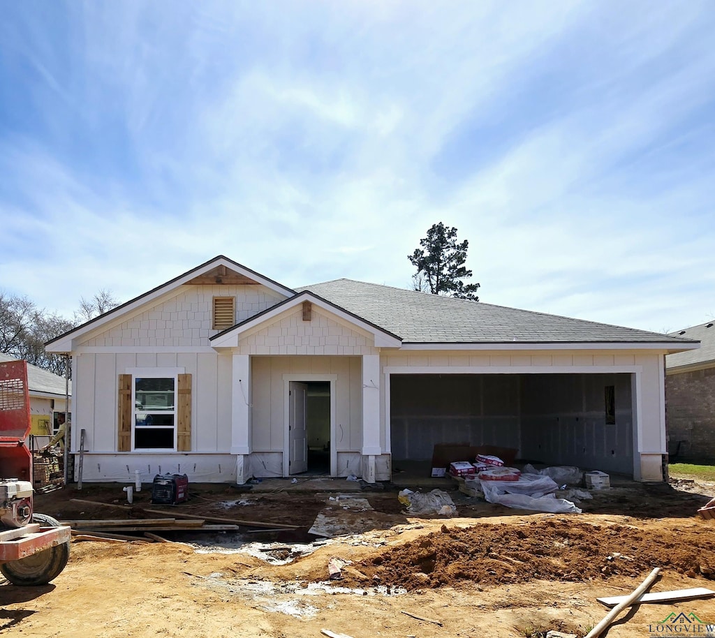 view of front of property with a garage, roof with shingles, and board and batten siding