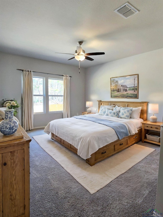 bedroom featuring carpet flooring, a ceiling fan, and visible vents