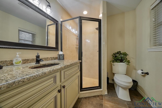 bathroom with vanity, toilet, and a shower with door