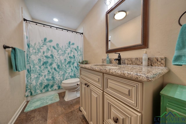 bathroom with vanity, a shower with shower curtain, and toilet