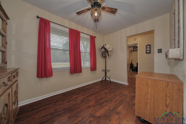 interior space featuring dark wood-type flooring and ceiling fan