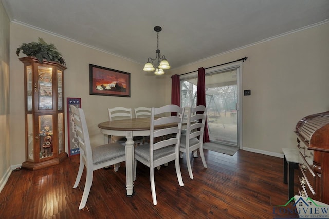 dining room with ornamental molding, dark hardwood / wood-style floors, and a notable chandelier