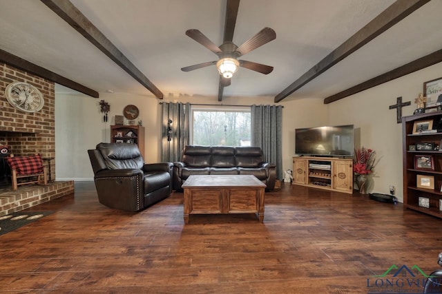 living room with ceiling fan, dark wood-type flooring, and beamed ceiling