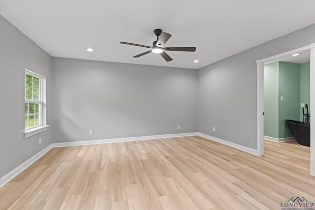 empty room featuring a ceiling fan, baseboards, recessed lighting, and light wood-style floors