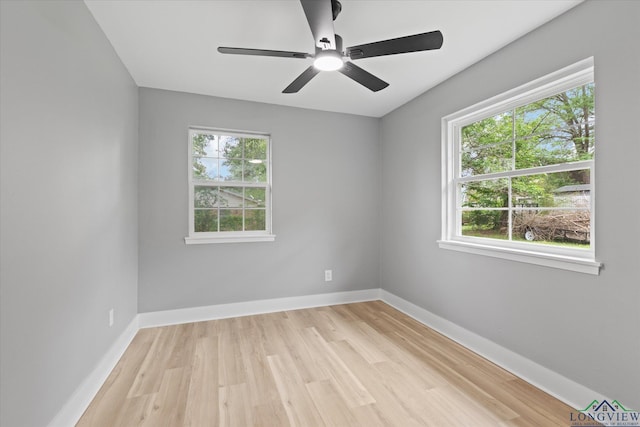 unfurnished room with ceiling fan, baseboards, and light wood-style floors