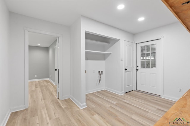laundry area featuring recessed lighting, light wood-type flooring, and baseboards