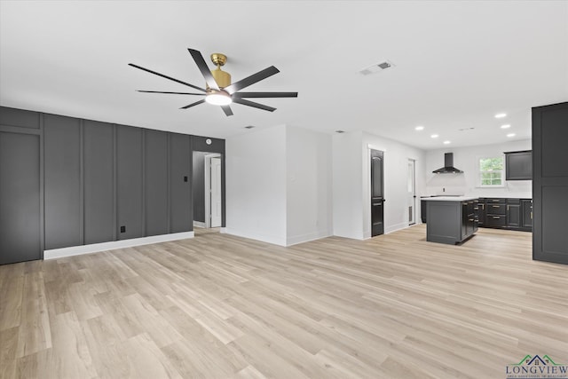 unfurnished living room with recessed lighting, light wood finished floors, visible vents, a ceiling fan, and baseboards