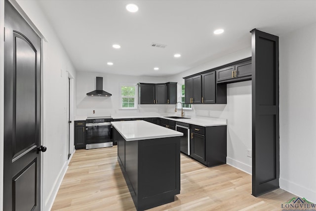 kitchen featuring wall chimney exhaust hood, a center island, a sink, electric range, and baseboards