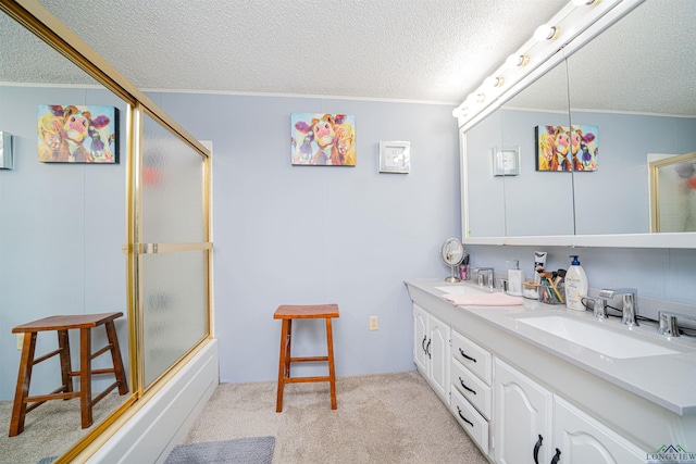 bathroom featuring vanity, shower / bath combination with glass door, and a textured ceiling