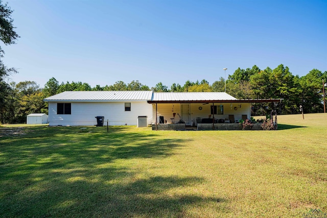 rear view of property with a lawn and covered porch