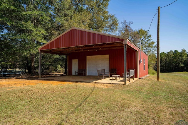 view of outbuilding featuring a lawn and a garage