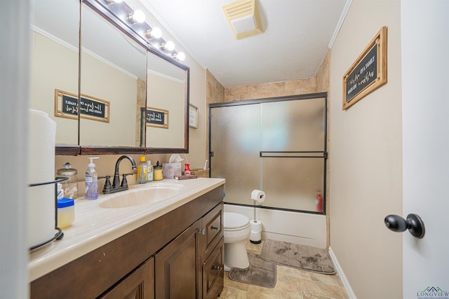 full bathroom featuring crown molding, vanity, enclosed tub / shower combo, and toilet