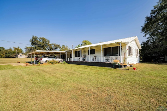 view of front of house with a carport, covered porch, and a front lawn