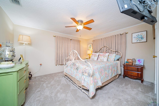 bedroom featuring light carpet, a textured ceiling, and ceiling fan