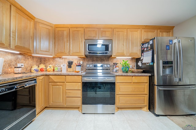 kitchen with stainless steel appliances and tasteful backsplash