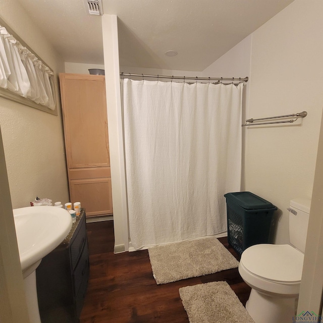 414 E Main St, Omaha, TX 75571 - full bathroom with wood finished floors, toilet, and a shower with shower curtain