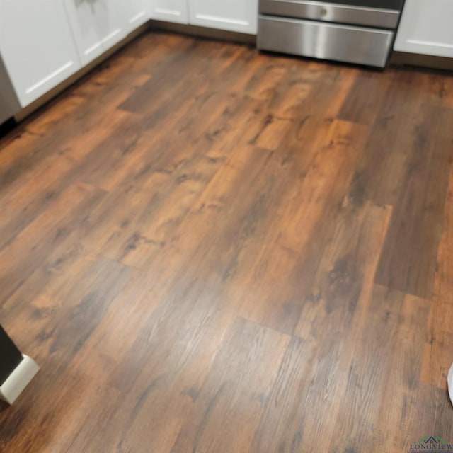 414 E Main St, Omaha, TX 75571 - kitchen view of dark wood-style floors and white cabinets
