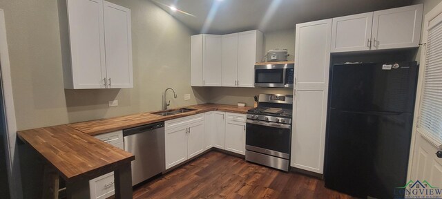 414 E Main St, Omaha, TX 75571 - kitchen featuring butcher block counters, appliances with stainless steel finishes, a sink, dark wood-style flooring, and white cabinetry