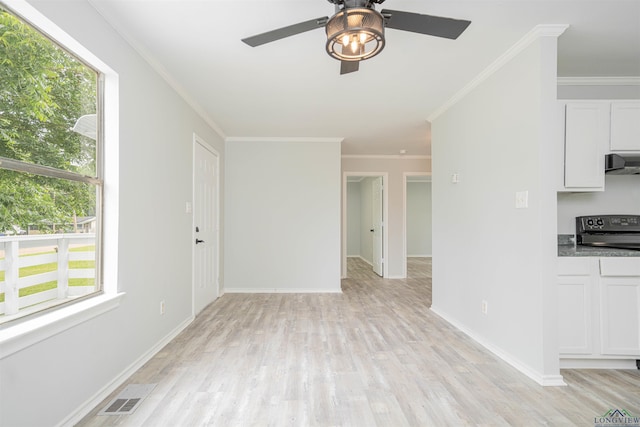 100 Dickson Ct, Kilgore, TX 75662 - unfurnished living room with plenty of natural light, a ceiling fan, light wood-style flooring, and crown molding