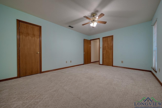 unfurnished bedroom with light colored carpet and ceiling fan