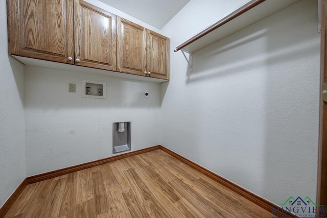 laundry area with cabinets, hookup for a washing machine, light hardwood / wood-style floors, and electric dryer hookup