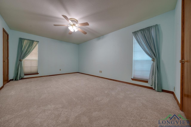 carpeted empty room featuring ceiling fan