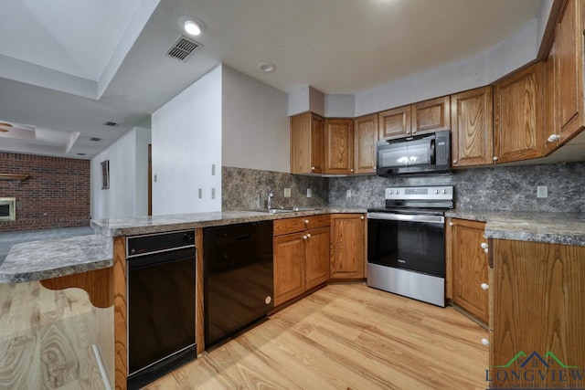 kitchen with backsplash, sink, light hardwood / wood-style flooring, and black appliances