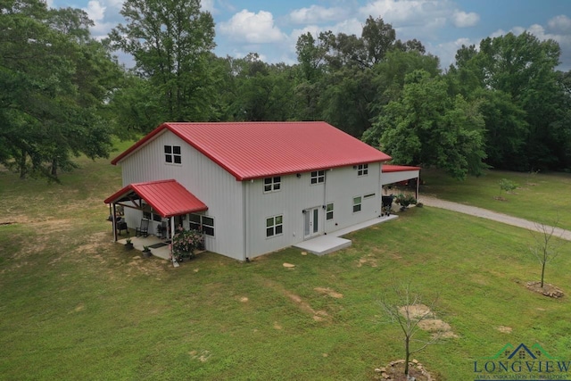 16272 County Road 223, Arp, TX 75750 - rear view of property featuring a yard, metal roof, a patio, driveway, and a carport