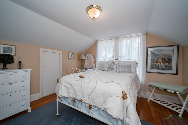 bedroom featuring hardwood / wood-style floors and lofted ceiling