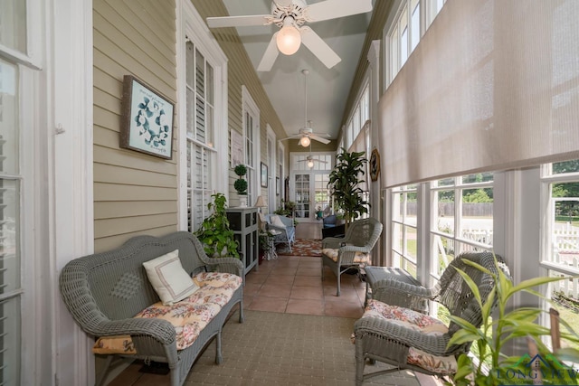 sunroom / solarium featuring ceiling fan and lofted ceiling