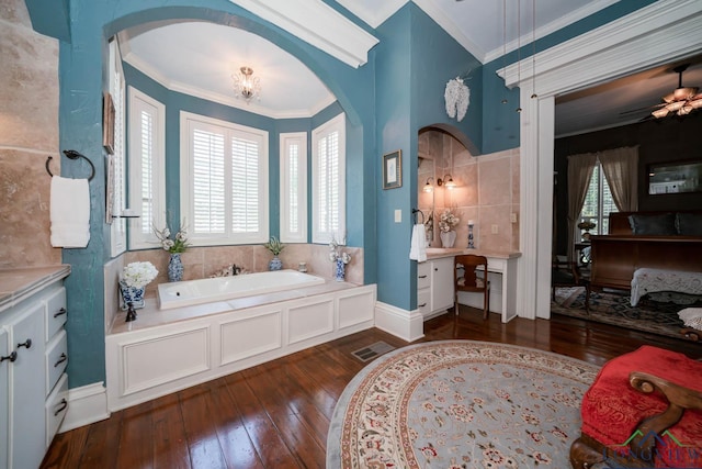 bathroom featuring hardwood / wood-style flooring, a bathing tub, and crown molding