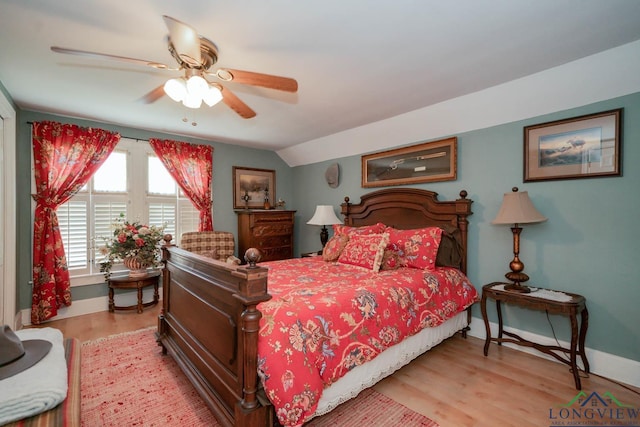 bedroom with light hardwood / wood-style flooring, ceiling fan, and lofted ceiling