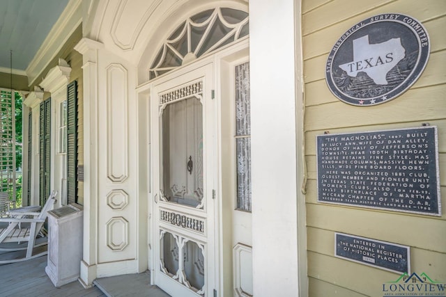 exterior space featuring ornamental molding and wood walls