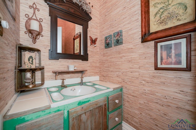 bathroom featuring wood walls and vanity