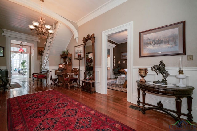 interior space with vaulted ceiling, dark hardwood / wood-style flooring, crown molding, and a chandelier