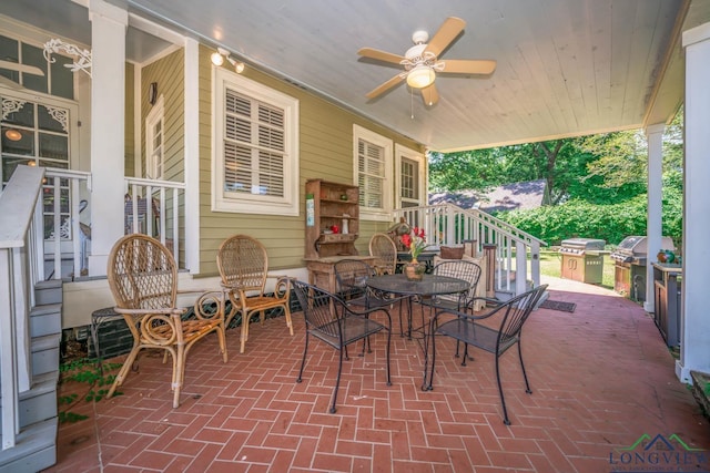 view of patio with a grill, ceiling fan, and exterior kitchen