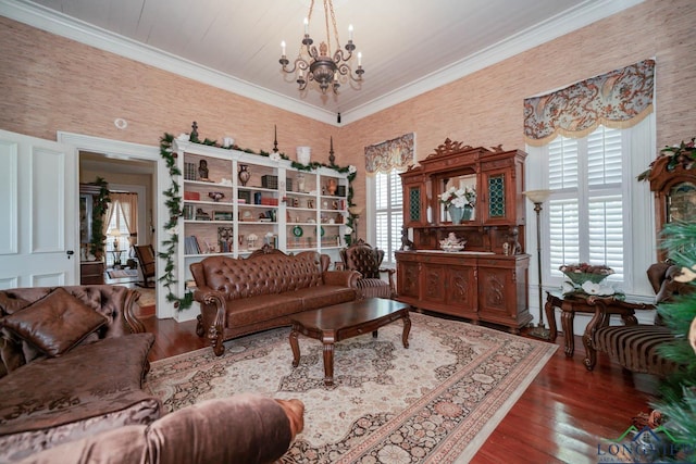 living room with crown molding, dark wood-type flooring, and a notable chandelier