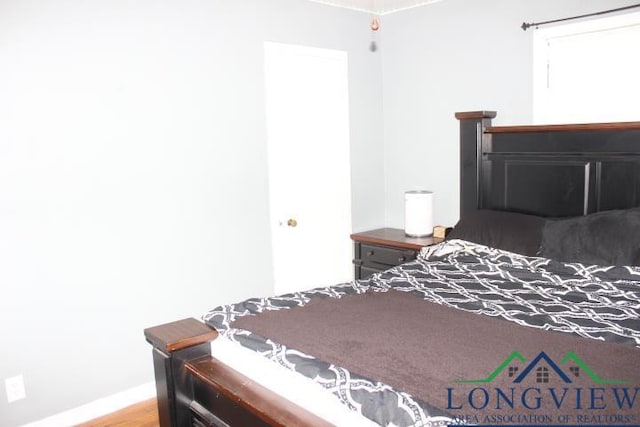 1212 N Edwards St, Gladewater, TX 75647 - bedroom with wood finished floors