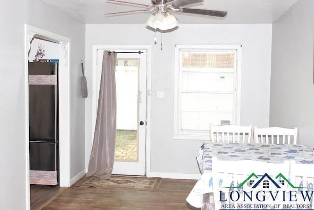 1212 N Edwards St, Gladewater, TX 75647 - dining space featuring wood finished floors, a ceiling fan, baseboards, and healthy amount of natural light