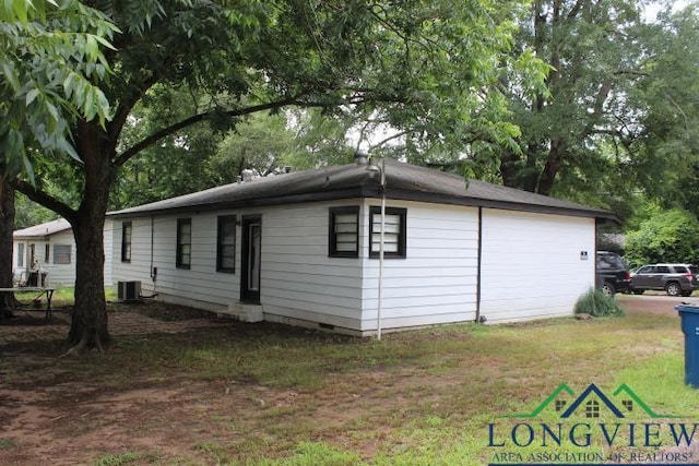 1212 N Edwards St, Gladewater, TX 75647 - view of side of home with central AC, a yard, and crawl space