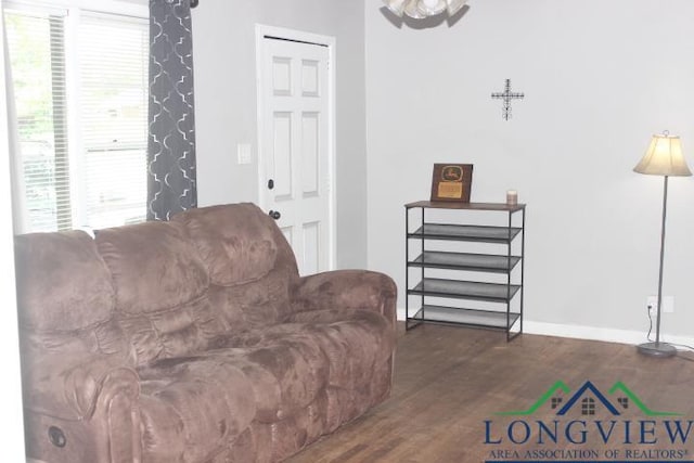 1212 N Edwards St, Gladewater, TX 75647 - living room with dark wood-style floors and baseboards