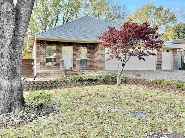 single story home with a garage and a front lawn