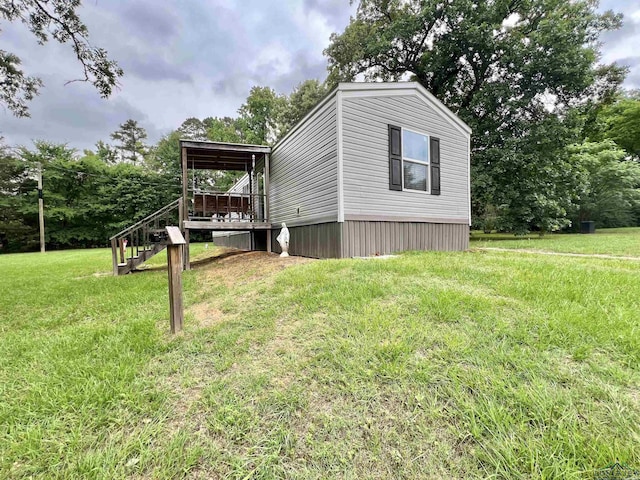 95 Montgomery St, Avinger, TX 75630 - view of side of home featuring stairs, a yard, and a deck