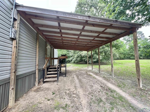 95 Montgomery St, Avinger, TX 75630 - view of car parking featuring a carport and dirt driveway